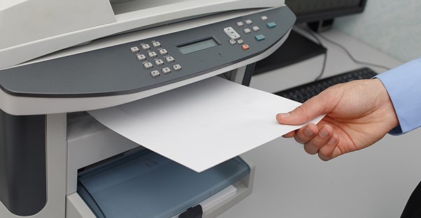 Person taking paper from a printer