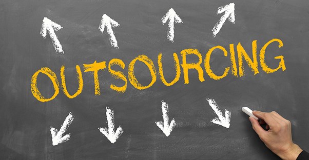 outsourcing written on chalkboard with arrows pointing out