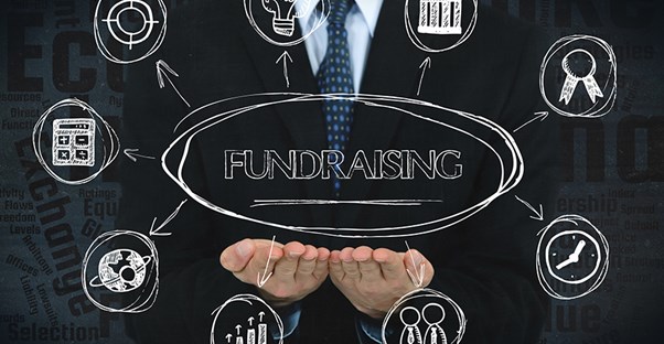 a man sketching fundraising ideas and steps on a chalk board to figure out how to fundraise