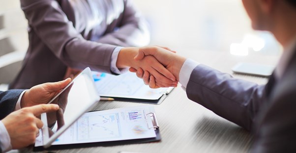 Businesspeople shaking hands over a business account deal