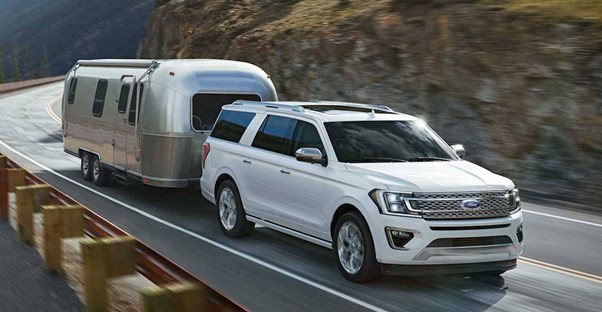 a white 2018 ford expedition pulling an airstream