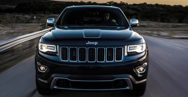 a black 2018 jeep grand cherokee driving toward the viewer