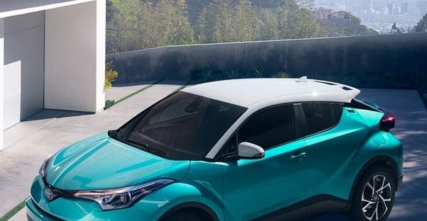 a teal and white 2018 toyota chr in a driveway