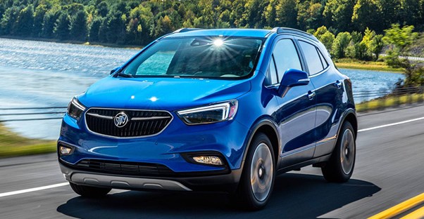 a blue 2018 buick encore driving down the road