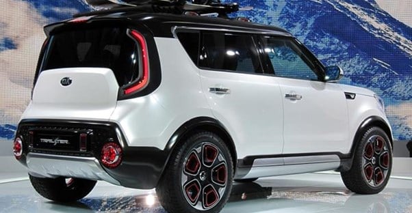 a white and black two toned 2018 kia soul in a showroom