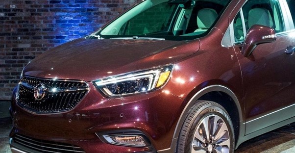 a maroon 2019 buick encore in a showroom
