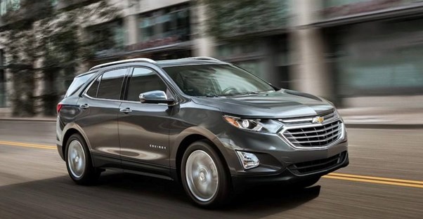 a grey 2019 chevrolet equinox driving down the road