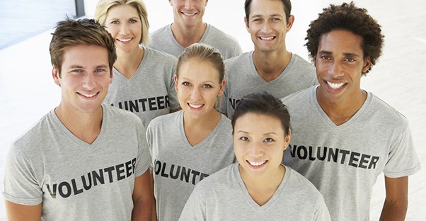 Group of people wearing "Volunteer" t-shirts