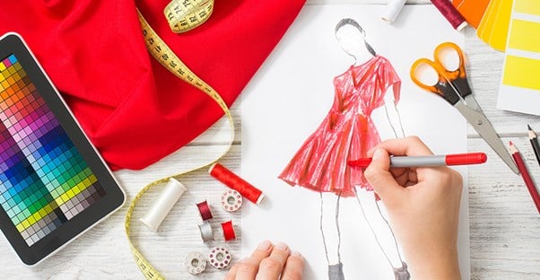 A fashion designer sketches a new dress