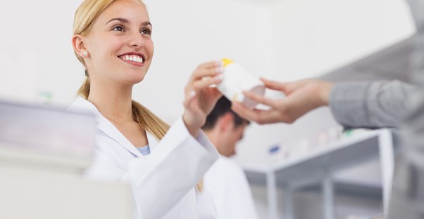 Happy female pharmacy technician smiling 
