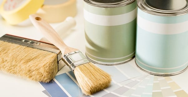 Paint cans and brushes being used in the interior design of an office.