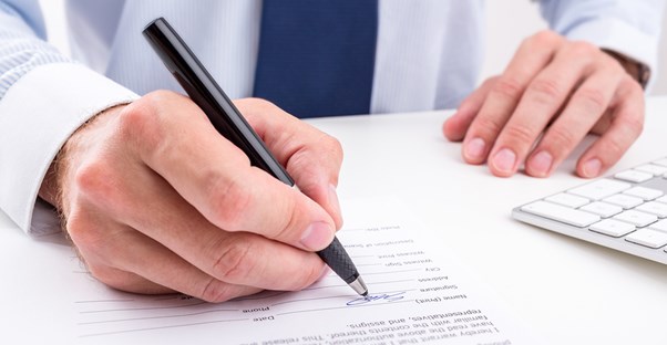 Insurance agent fills out paperwork