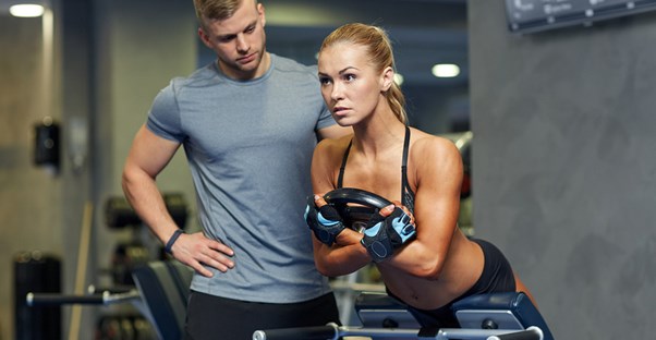 A personal trainer works with his client