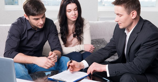 An insurance agent consults with clients