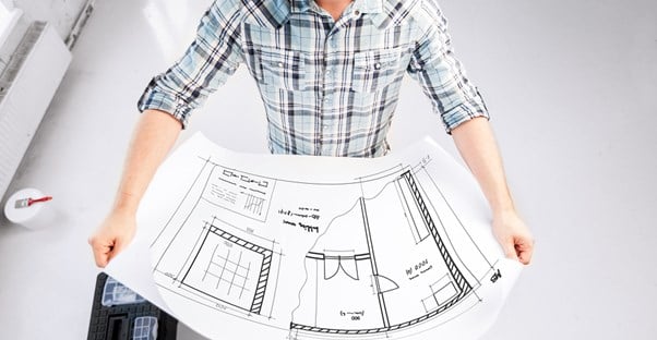 An architect looks at a blueprint