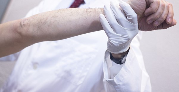 A doctor stretches a forearm