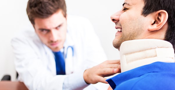 Doctor treating neck pain