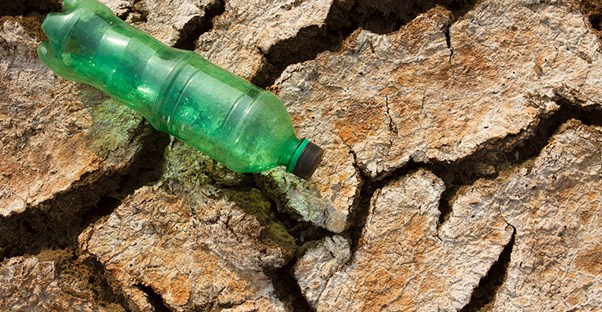 water bottle laying on rocks to represent treatments for dry mouth
