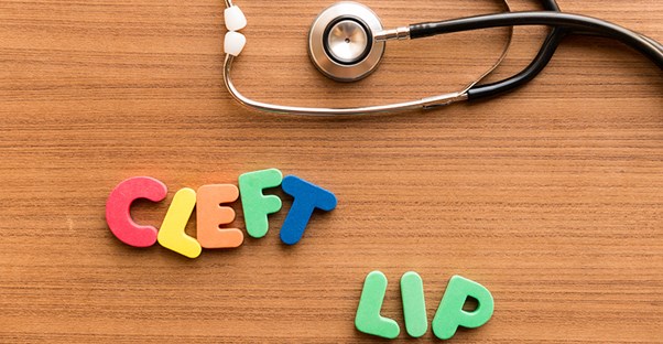 Cleft lip spelled out in alphabet toys with a stethoscope.