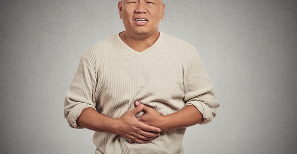Man holding stomach in pain. Pancreatitis cure. 