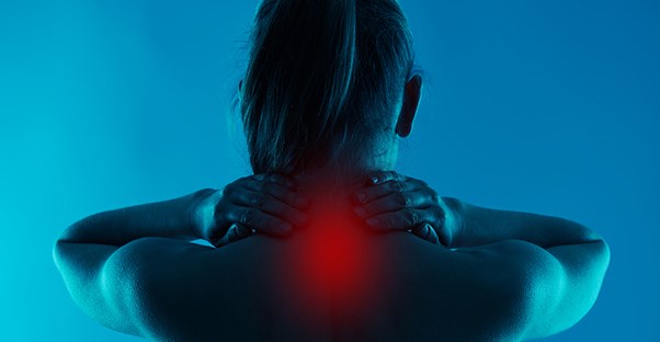 the neck of a woman glows red with chronic neck pain