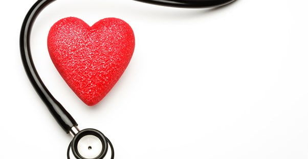a stethoscope surrounds a heart for heart disease
