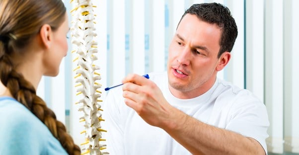 a doctor discusses ankylosing spondylitis with a patient