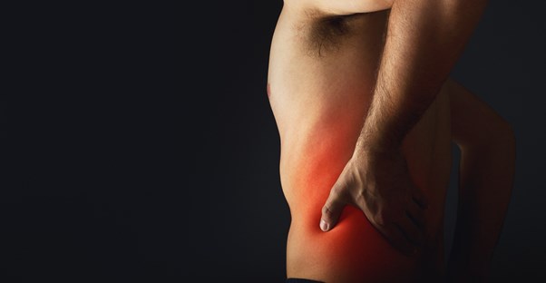 the lower back of a man shows signs of nerve pain