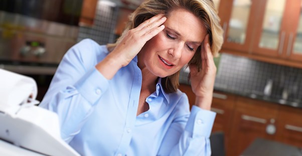 a woman experiencing tension headaches