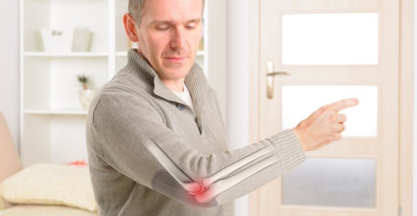a man shows his acute pain is located in his elbow