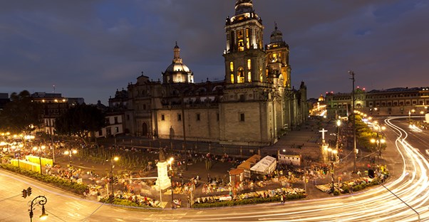 The Metropolitan Cathedral of Mexico City is lit up with lights at night.