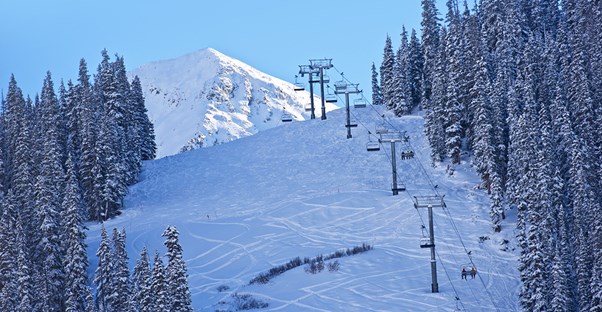 a chairlift brings skiers to the top of a ski run