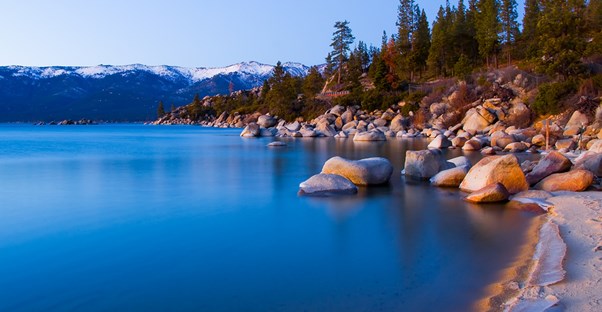 the rocky coastline along the calm waters of Lake Tahoe