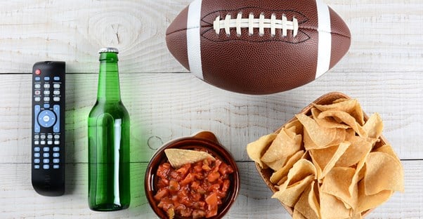 Items sitting on a table at a super bowl party.
