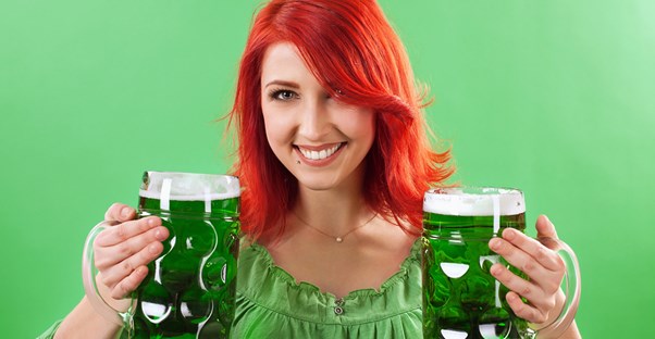 Woman drinking green beer for St. Patrick's Day