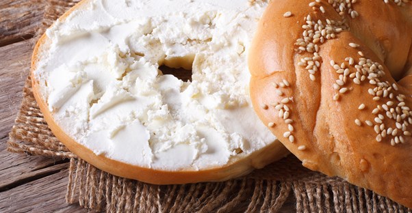 A bagel smeared with cream cheese