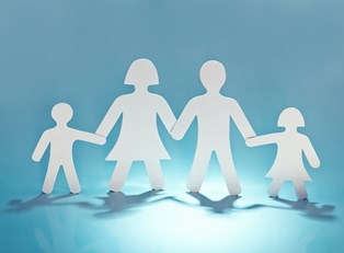 a paper cutout of a family holding hands