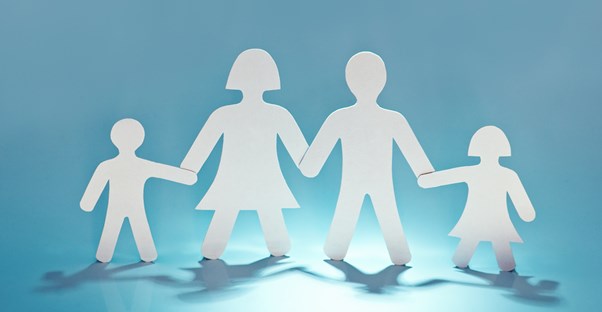 a paper cutout of a family holding hands