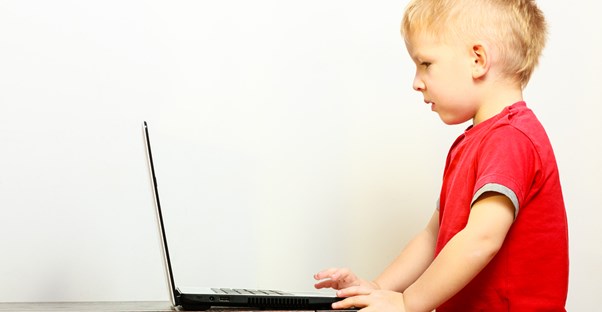 A little boy using a laptop