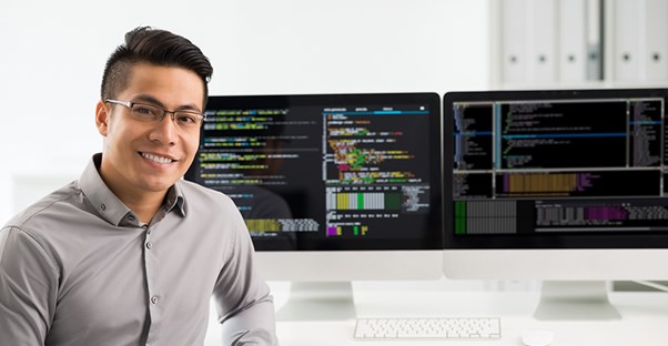 a man at his desk working a job as a software engineer on split screens with coding languages on them