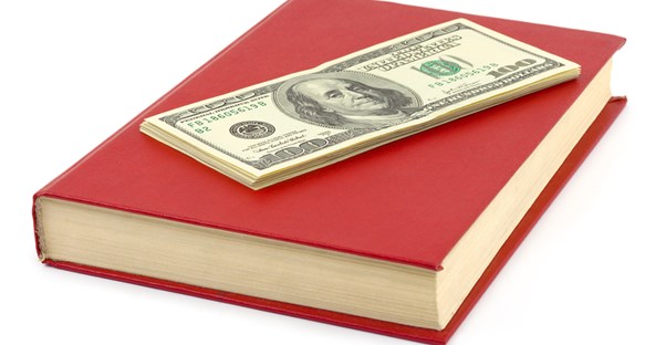 an image of money and a law textbook that will both be used for a juris doctor degree