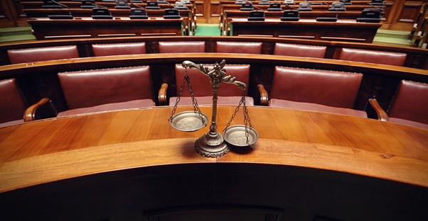 an image of scales in a courtroom that symbolizes the pros and cons of a juris doctor degree