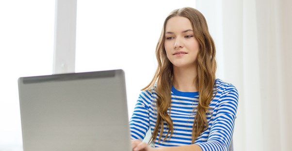 A young high school student attends classes online