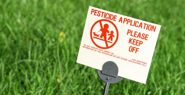 a pesticide in the lawn warns family members to keep off