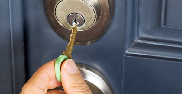 a key being placed into a door deadbolt lock