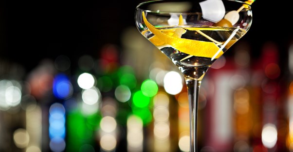 a potent cocktail sparkles in the light of the bar