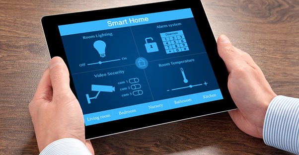 A man operates his home automation system from his tablet.