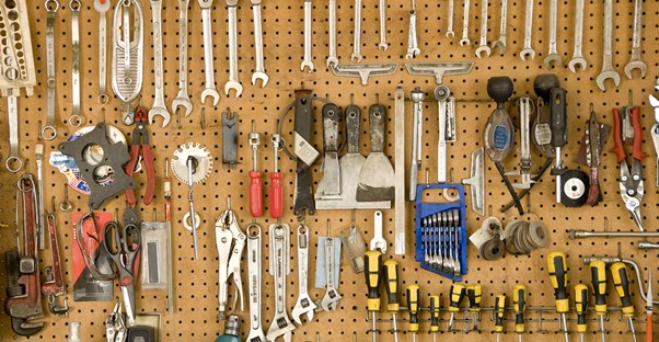 Tools hung on an inexpensive storage rack in a garage