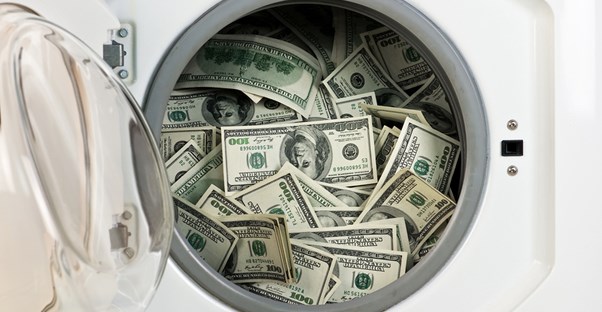 A green washing machine filled with the cash it saved the owner