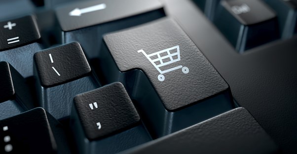 A keyboard button with a shopping cart to represent cyber monday